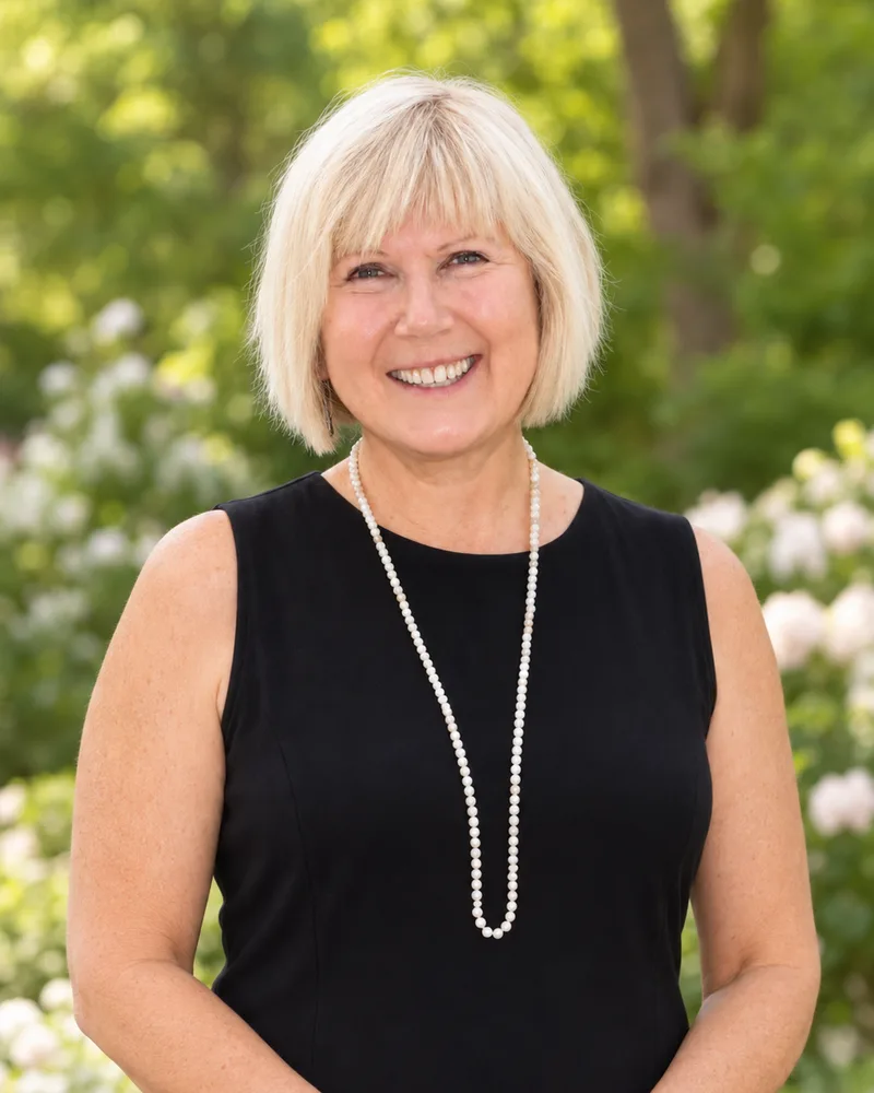 Rev. Ellen Barron, smiling, in a garden